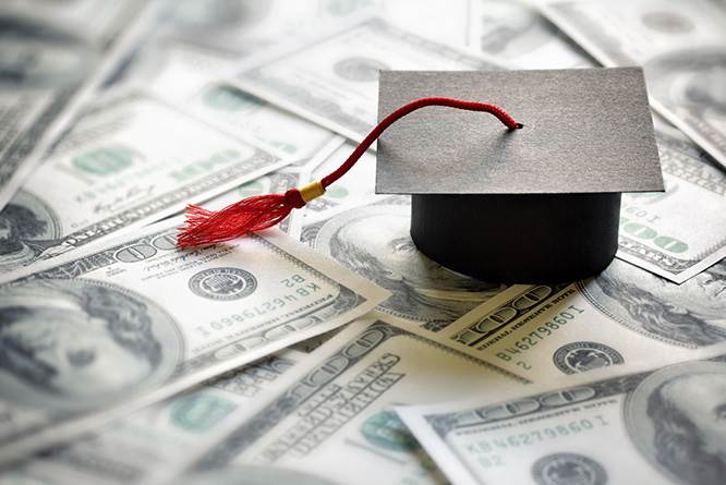 pile of money with a graduation cap on top