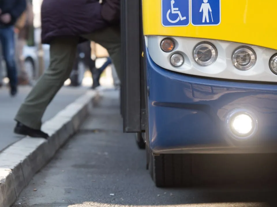 Close up of someone stepping onto a bus